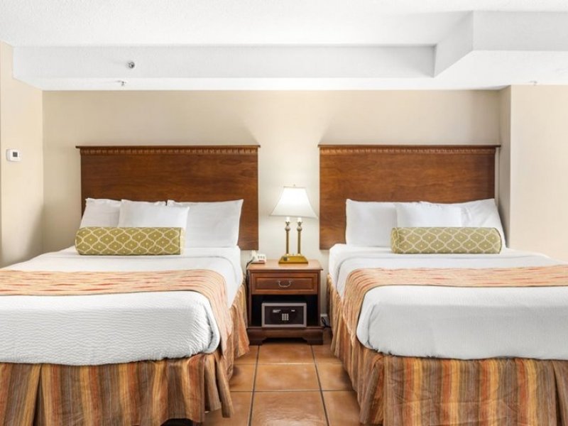 a hotel room with two beds and a nightstand