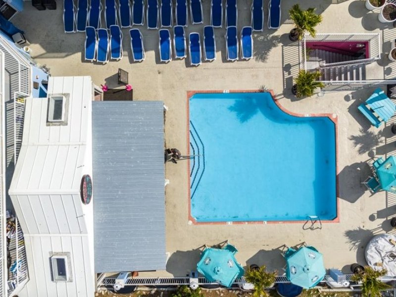 an overhead view of a pool and beach chairs